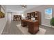 Home office features a large desk, extensive bookshelves, and ample natural light at 5832 Sleepy Willow St, Las Vegas, NV 89148