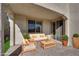 Inviting covered patio showcasing comfortable seating, stone floors, and easy access to the interior through sliding glass doors at 5832 Sleepy Willow St, Las Vegas, NV 89148