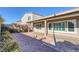 This beautiful home features a covered patio and desert landscaping at 5977 Ancient Peaks Ave, Las Vegas, NV 89141