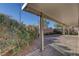Covered patio and desert landscaping make this backyard perfect for relaxing and entertaining at 5977 Ancient Peaks Ave, Las Vegas, NV 89141