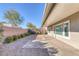This backyard features a brick patio and desert landscaping with a covered patio at 5977 Ancient Peaks Ave, Las Vegas, NV 89141