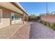 A covered patio extends outdoor living in this backyard featuring desert landscaping at 5977 Ancient Peaks Ave, Las Vegas, NV 89141