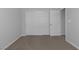 Carpeted bedroom includes closet and entry doors with neutral walls at 5977 Ancient Peaks Ave, Las Vegas, NV 89141