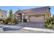 Inviting single-story home boasts stone detailing, a tiled roof, a two-car garage, and mature landscaping at 5977 Ancient Peaks Ave, Las Vegas, NV 89141
