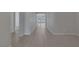 Long hallway with tile flooring and neutral gray walls leading to other areas of the house at 5977 Ancient Peaks Ave, Las Vegas, NV 89141