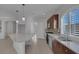 Bright kitchen featuring a granite island, stainless steel appliances, ample cabinet space, and tile flooring at 5977 Ancient Peaks Ave, Las Vegas, NV 89141