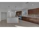 Spacious kitchen with a center island, wood cabinets, stainless steel appliances, and tile flooring at 5977 Ancient Peaks Ave, Las Vegas, NV 89141