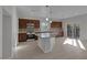 Open kitchen features dark wood cabinets, granite countertops, stainless steel appliances, and an island at 5977 Ancient Peaks Ave, Las Vegas, NV 89141