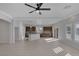 Living space with tile floors and a view into the kitchen with stainless appliances at 5977 Ancient Peaks Ave, Las Vegas, NV 89141