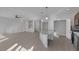 Open-concept living space with tile floors, island counter, and stainless steel appliances at 5977 Ancient Peaks Ave, Las Vegas, NV 89141