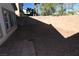 Enclosed backyard features a brick wall and low-maintenance landscaping with gravel and a small patio at 6020 Genovese Ave, Las Vegas, NV 89141