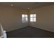 Spacious bedroom with neutral carpet, paint, and windows providing natural light at 6020 Genovese Ave, Las Vegas, NV 89141