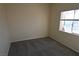 Neutral carpet and walls in this bedroom, as well as a view from a window at 6020 Genovese Ave, Las Vegas, NV 89141