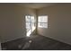 Bedroom with neutral carpet and paint, featuring dual windows at 6020 Genovese Ave, Las Vegas, NV 89141