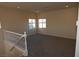 Bonus room features recessed lighting, neutral paint and carpet, and two windows offering natural light at 6020 Genovese Ave, Las Vegas, NV 89141