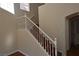 Bright staircase with white banister and wood-look flooring leading to the upper level at 6020 Genovese Ave, Las Vegas, NV 89141