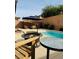 Outdoor living space showcasing a sparkling pool, patio furniture, and privacy fencing at 6495 Little Harbor Ct, Las Vegas, NV 89141