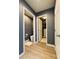 Bathroom featuring wood flooring, gray walls, and two open doorways: one to a toilet and one to a walk-in closet at 6495 Little Harbor Ct, Las Vegas, NV 89141