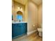 Stylish half bath with modern fixtures, vanity with blue cabinets and updated features perfect for guests at 6495 Little Harbor Ct, Las Vegas, NV 89141