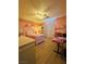 Bright bedroom with a ceiling fan, bed, dresser, desk and laminate flooring at 6495 Little Harbor Ct, Las Vegas, NV 89141