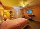 Bright pink bedroom with a ceiling fan, bed, TV, decor, and a white storage shelf at 6495 Little Harbor Ct, Las Vegas, NV 89141