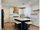 Contemporary kitchen featuring stainless steel appliances, an island with seating, and modern cabinetry at 6495 Little Harbor Ct, Las Vegas, NV 89141