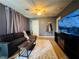 Comfortable living room featuring a plush rug, sofa, and large flat screen TV at 6495 Little Harbor Ct, Las Vegas, NV 89141