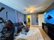 Cozy living area with comfortable seating, large window, and an exercise machine at 6495 Little Harbor Ct, Las Vegas, NV 89141