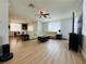Spacious open-concept living room featuring modern lighting, sleek ceiling fan, and contemporary furnishings at 6495 Little Harbor Ct, Las Vegas, NV 89141