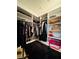 Walk-in closet with custom built-in shelving and storage space for clothes and accessories at 6495 Little Harbor Ct, Las Vegas, NV 89141