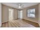 Bright bedroom features wood-look floors, ceiling fan, and a window providing natural light at 701 Capri Dr # 16B, Boulder City, NV 89005