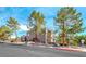 Exterior angle of complex featuring mature landscaping and reserved parking at 701 Capri Dr # 16B, Boulder City, NV 89005