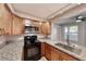 Modern kitchen with stainless steel appliances, granite countertops, and dark brown cabinets at 701 Capri Dr # 16B, Boulder City, NV 89005