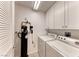 Functional laundry room equipped with modern washer and dryer, plus water filtration system at 701 Capri Dr # 16B, Boulder City, NV 89005