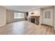 Inviting living room with wood floors, fireplace, and a large window overlooking the neighborhood at 701 Capri Dr # 16B, Boulder City, NV 89005