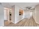 Open-concept living area with view to the kitchen, wood floors, and a ceiling fan at 701 Capri Dr # 16B, Boulder City, NV 89005