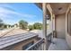 Open-air balcony features decorative railings and great views of the surrounding neighborhood and treeline at 8216 Swallow Falls St, North Las Vegas, NV 89085