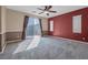 Spacious bedroom featuring neutral carpet, modern ceiling fan, and sliding glass door to balcony at 8216 Swallow Falls St, North Las Vegas, NV 89085
