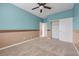 A carpeted bedroom featuring neutral walls, a ceiling fan, and a closet at 8216 Swallow Falls St, North Las Vegas, NV 89085