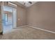 A carpeted bedroom featuring neutral walls, access to a balcony and an HVAC system at 8216 Swallow Falls St, North Las Vegas, NV 89085