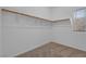 Walk-in closet with built-in shelving and carpeted floor at 8216 Swallow Falls St, North Las Vegas, NV 89085