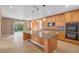 Modern kitchen with a large island, stainless steel appliances, and an adjacent dining area at 8216 Swallow Falls St, North Las Vegas, NV 89085