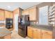 Bright kitchen featuring granite countertops, stainless steel appliances, and ample cabinet space at 8216 Swallow Falls St, North Las Vegas, NV 89085