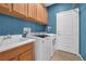 Laundry room with washer, dryer, utility sink and storage at 8216 Swallow Falls St, North Las Vegas, NV 89085