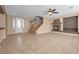 Bright, open living room with fireplace, staircase, and ample natural light at 8216 Swallow Falls St, North Las Vegas, NV 89085