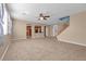 Open-concept living space with stairs, tile floor, and view into modern kitchen at 8216 Swallow Falls St, North Las Vegas, NV 89085