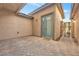Charming brick-paved patio with a blue-framed door and iron gate, ideal for outdoor relaxation at 8216 Swallow Falls St, North Las Vegas, NV 89085