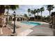 Community pool surrounded by lounge chairs and palm trees, offering a resort-like experience at 8216 Swallow Falls St, North Las Vegas, NV 89085