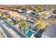 Beautiful aerial view of backyard oasis showcasing a sparkling pool, mature palm trees, and well-maintained landscaping at 8354 Woodland Prairie Ave, Las Vegas, NV 89129