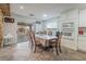 Cozy dining room featuring tile floors, white cabinets, and sliding door access to the patio at 8354 Woodland Prairie Ave, Las Vegas, NV 89129